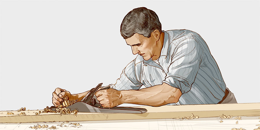 نجار يستعمل اداة بمهارة في نشر قطعة من الخشب