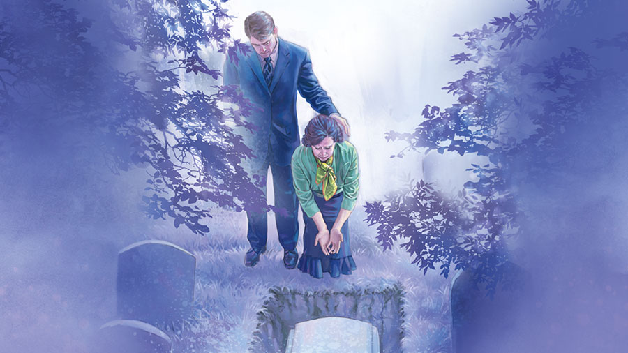 زوجان يبكيان فيما يوضع تابوت في القبر