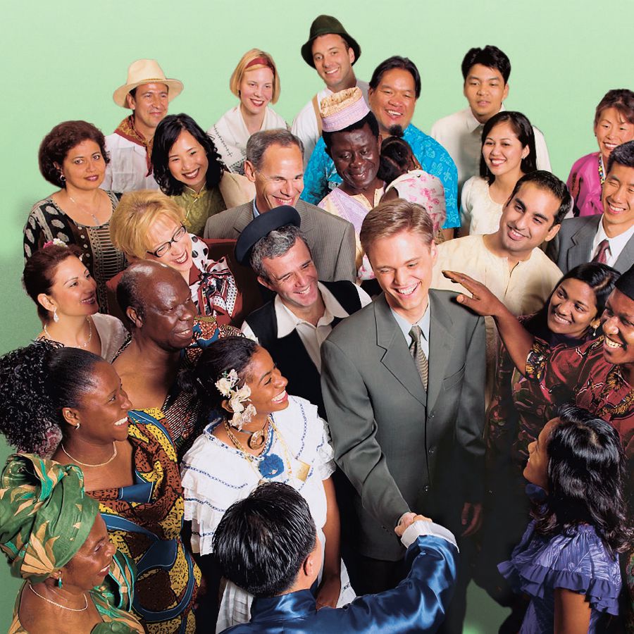 A man is welcomed into a happy international group of Jehovah’s Witnesses