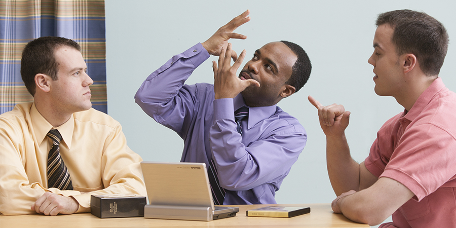 Two of Jehovah’s Witnesses studying the Bible with a man