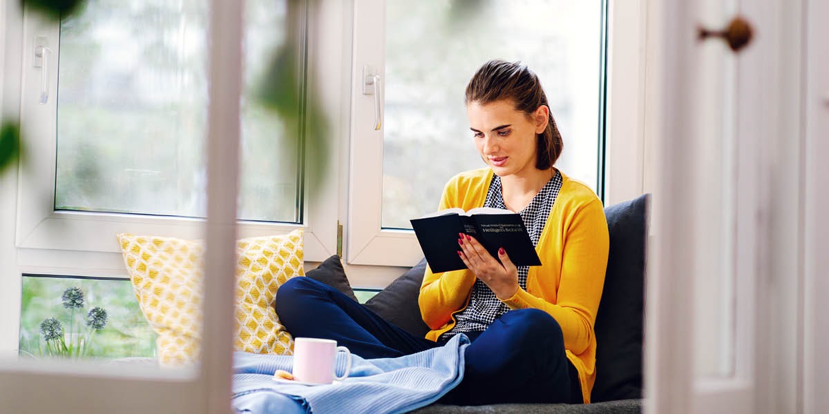 A young woman reads the Bible