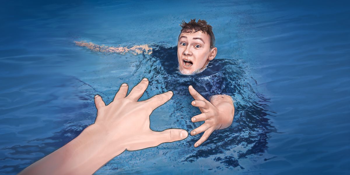 Topící se muž natahuje ruku k člověku, který ho chce zachránit