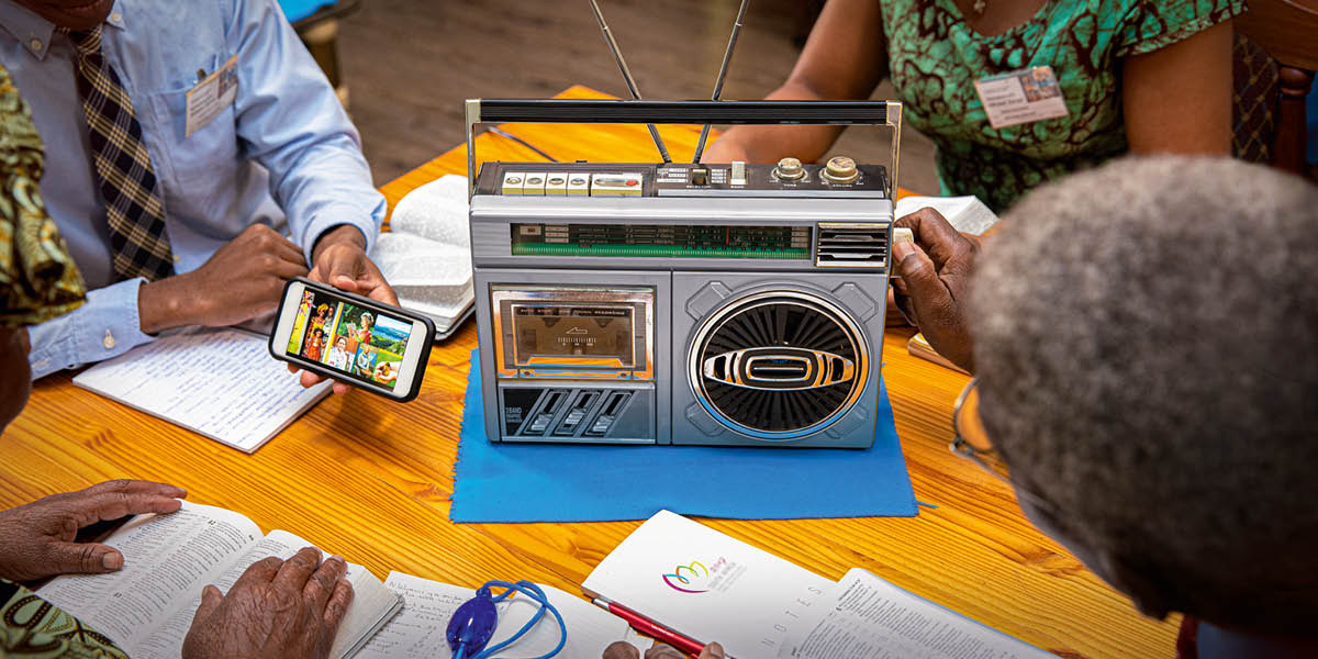 Brüder und Schwestern verfolgen das Kongressprogramm im Radio.