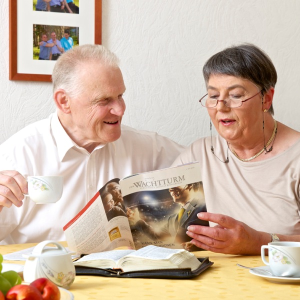 Roswitha and her husband studying a Bible-based publication together