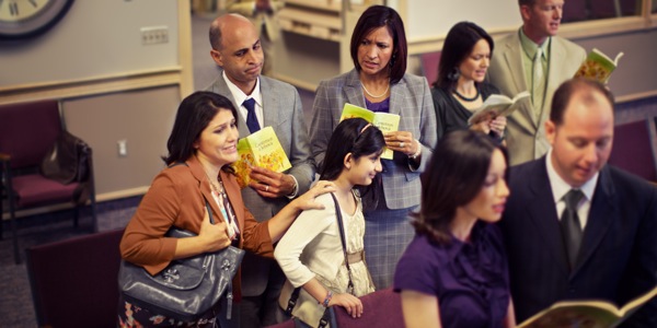A mother and her daughter arriving late at a Christian meeting