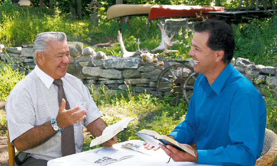 One of Jehovah’s Witnesses studies the Bible with a man