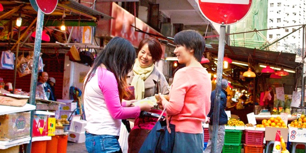 Jehovah’s Witnesses sharing a Bible-based publication with a woman