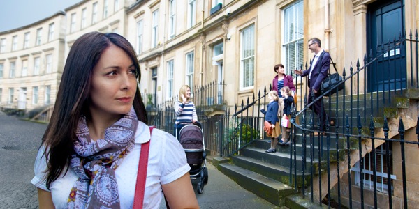 A woman looking back at a happy family
