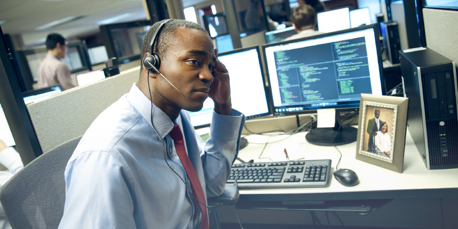 An unhappy man daydreams at work