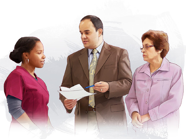 A woman and her health-care agent talk with a member of the hospital staff