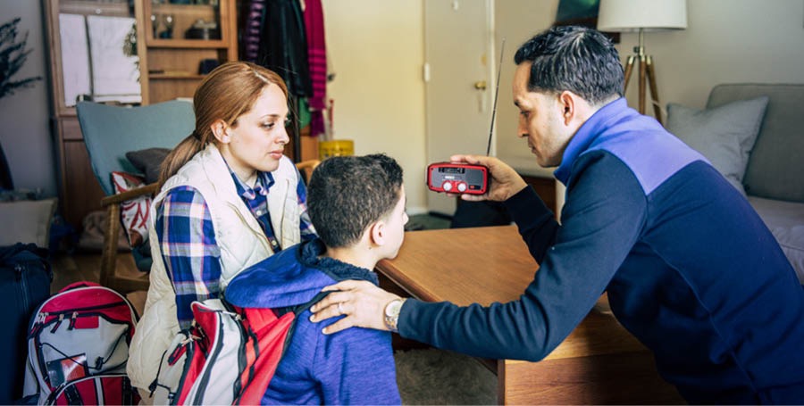 A family listens to a radio