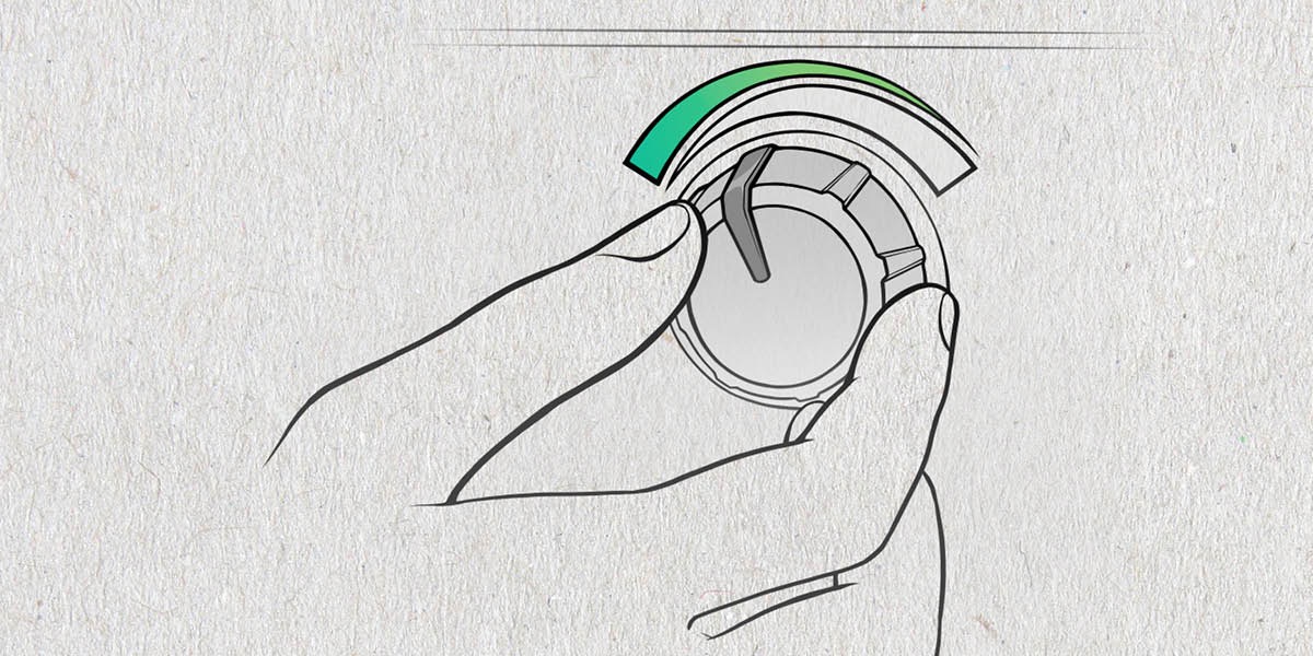 A person turns down a thermostat