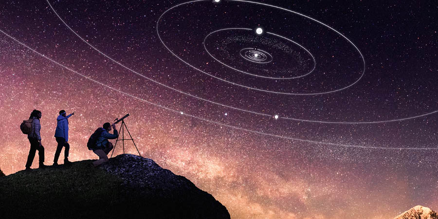 Hikers, on top of a mountain, gazing at stars and planets in the night sky. One of them looks through a telescope.