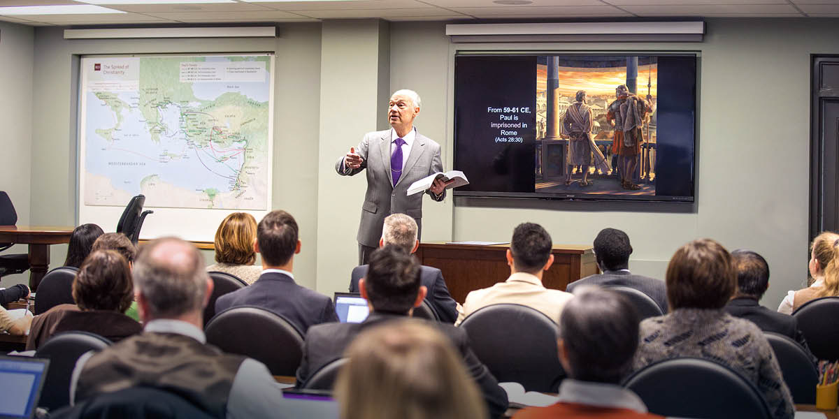 Brother Stephen Lett of the Governing Body speaking to Gilead students in a classroom.