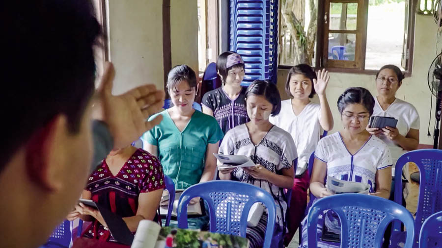 A missionary brother calling on a sister to give a comment at a congregation meeting.