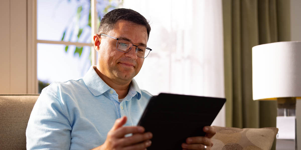 A brother using his electronic tablet.