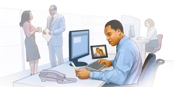 A husband has a picture of his wife on his desk at work