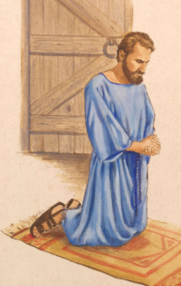 Behind a closed door, in a private room, a man kneels in prayer