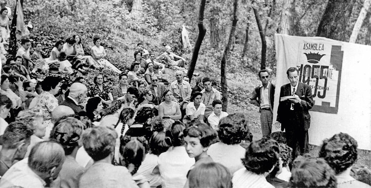 Brother Franz speaking to a group of Jehovah’s Witnesses gathered in the woods.