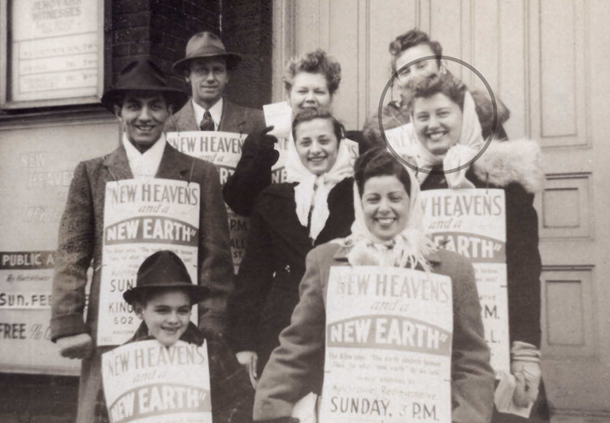 Camilla and a small group of brothers and sisters wearing placards and holding handbills.