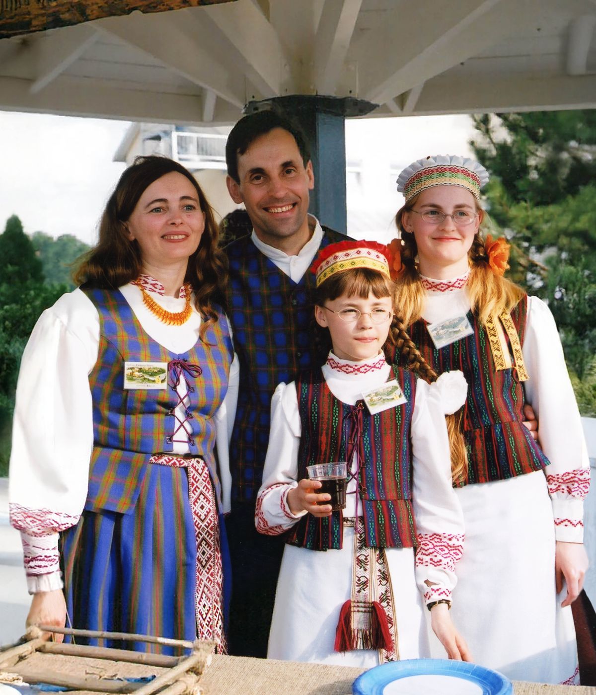 Virgilijus, Lidija, Oksana, and Svajūnė posing for a picture outdoors at the Lithuania branch expansion dedication.