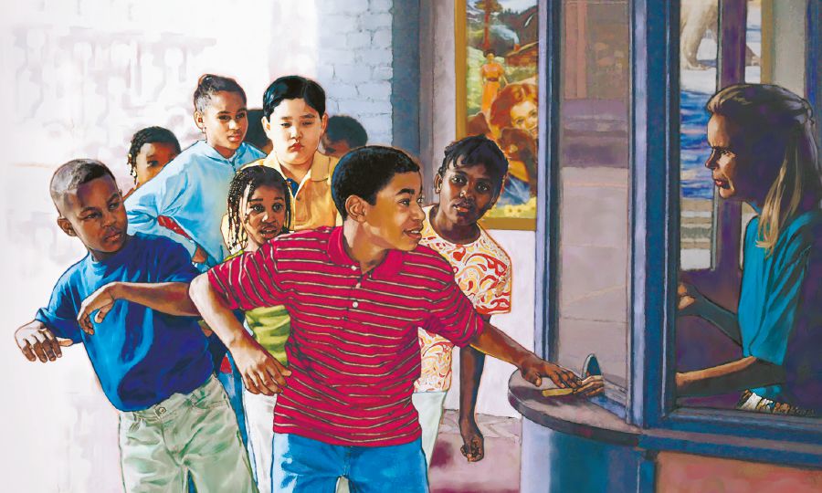 A boy pushes another boy out of the way so he can be first in line