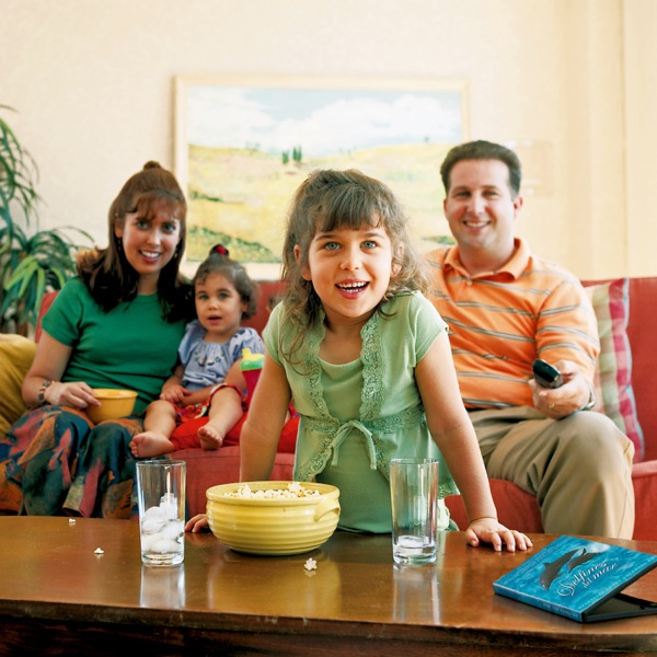 A happy family watching a movie that is wholesome entertainment