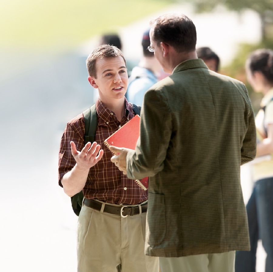 A Witness youth explains his faith to a man