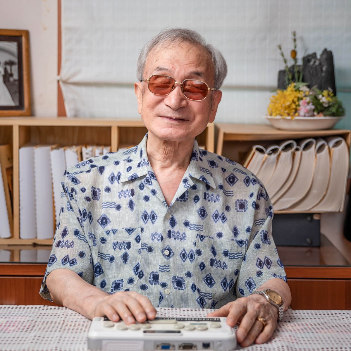 A blind man using a braille notetaker.