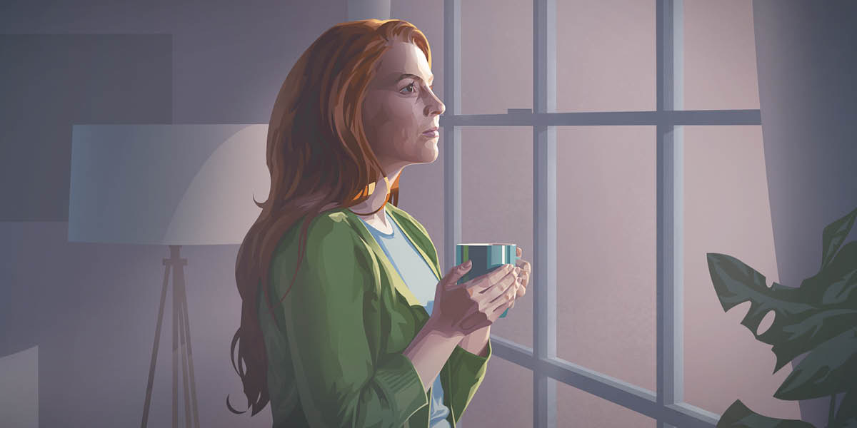 A woman at home, gazing out of a window.