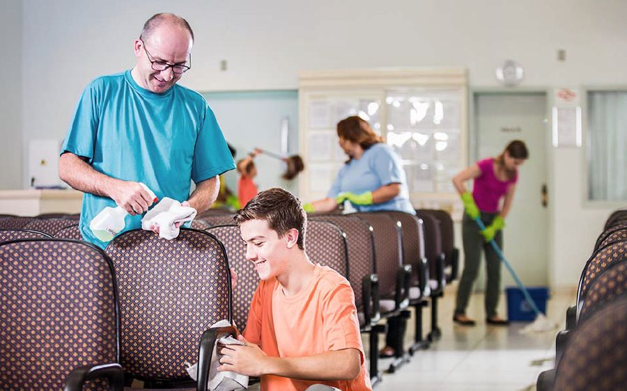 Brothers and sisters clean the Kingdom Hall