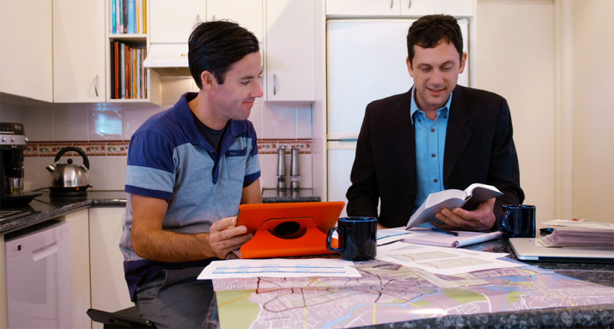 Brother Richards reads a scripture to Ben