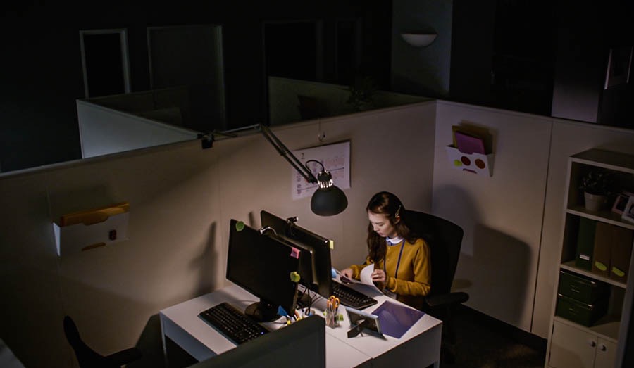 The same pioneer sister working late at night in a dark office.