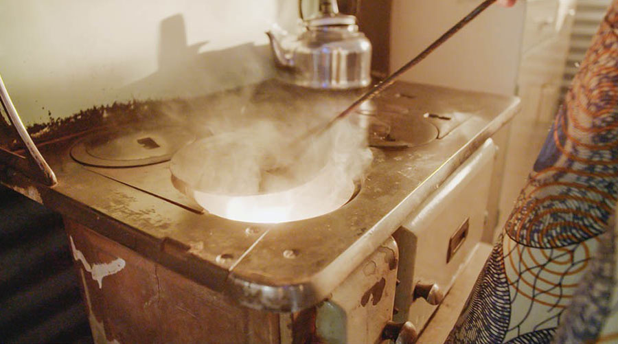 The Bible student burning the baby’s amulet in her kitchen stove.