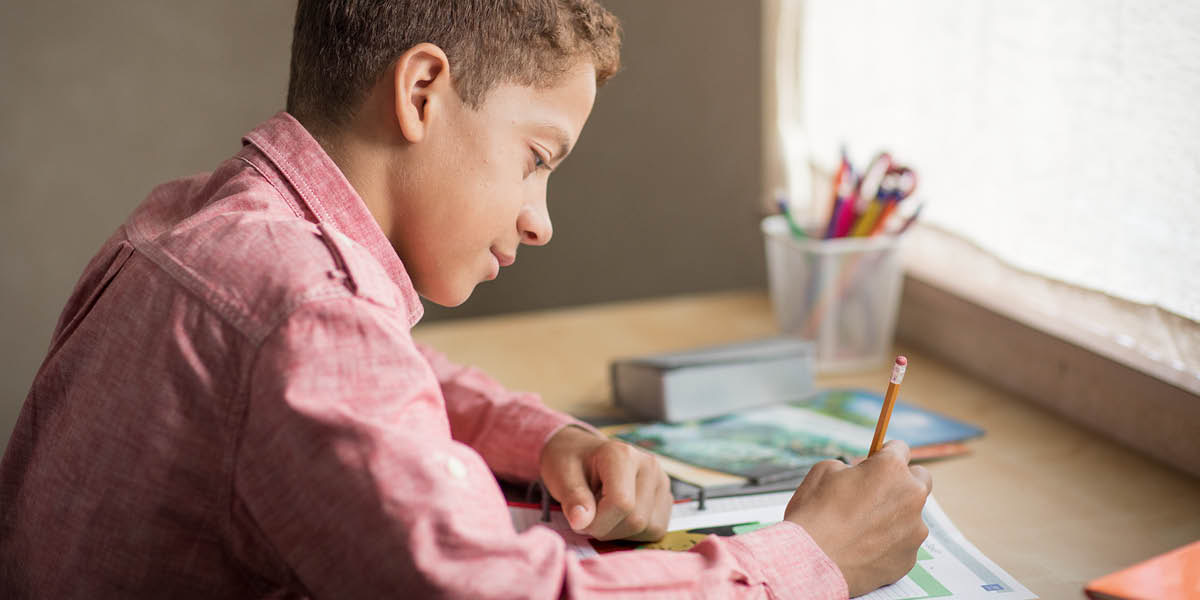 A young brother sitting at his desk, absorbed in personal study.