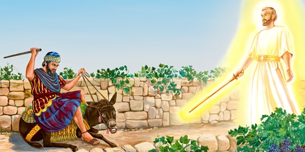 The donkey talks to Balaam because an angel is blocking the road