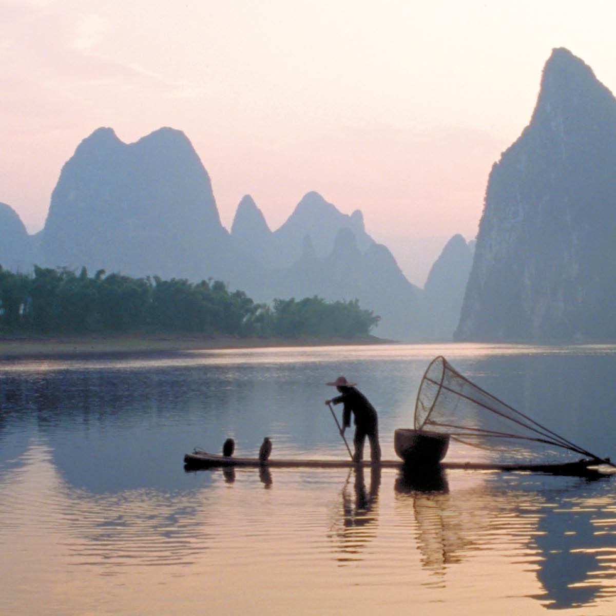 A man crosses a river on a raft