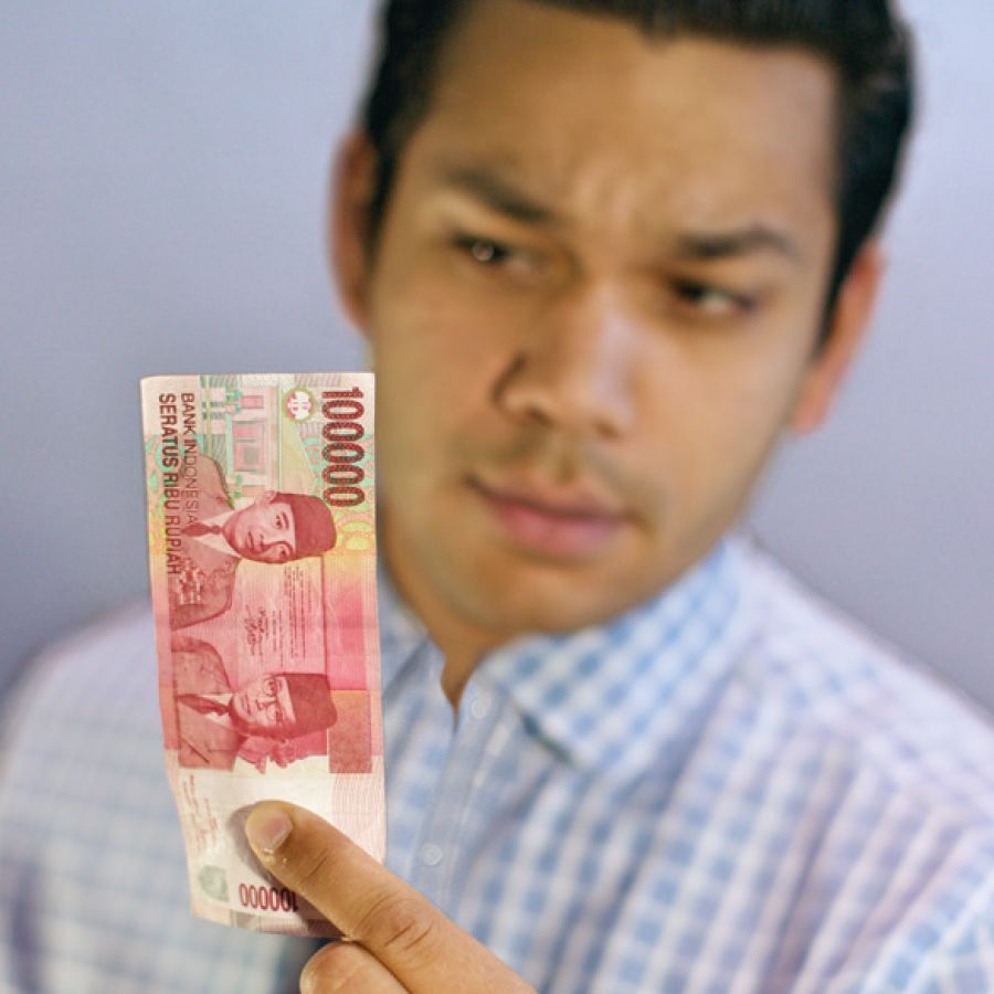 A man looks at money