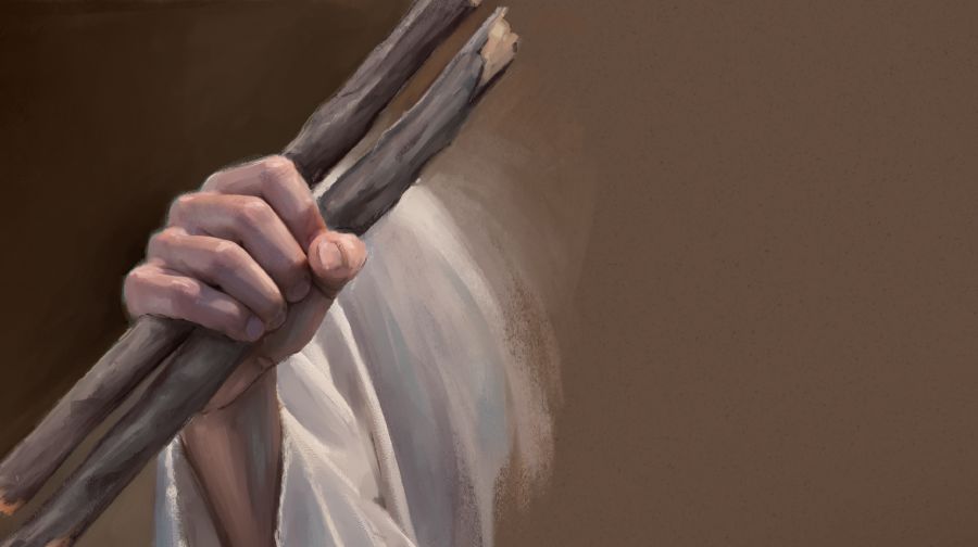 Ezekiel holding two sticks together in one hand.