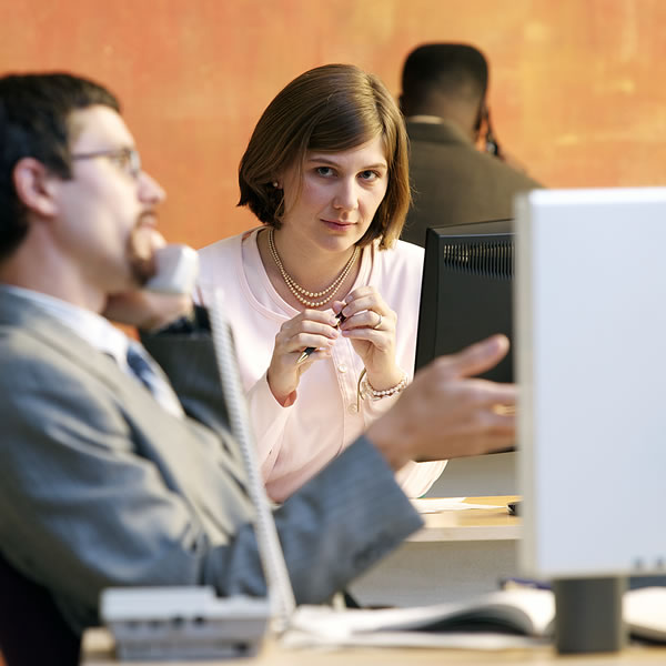 A woman looking at a male coworker