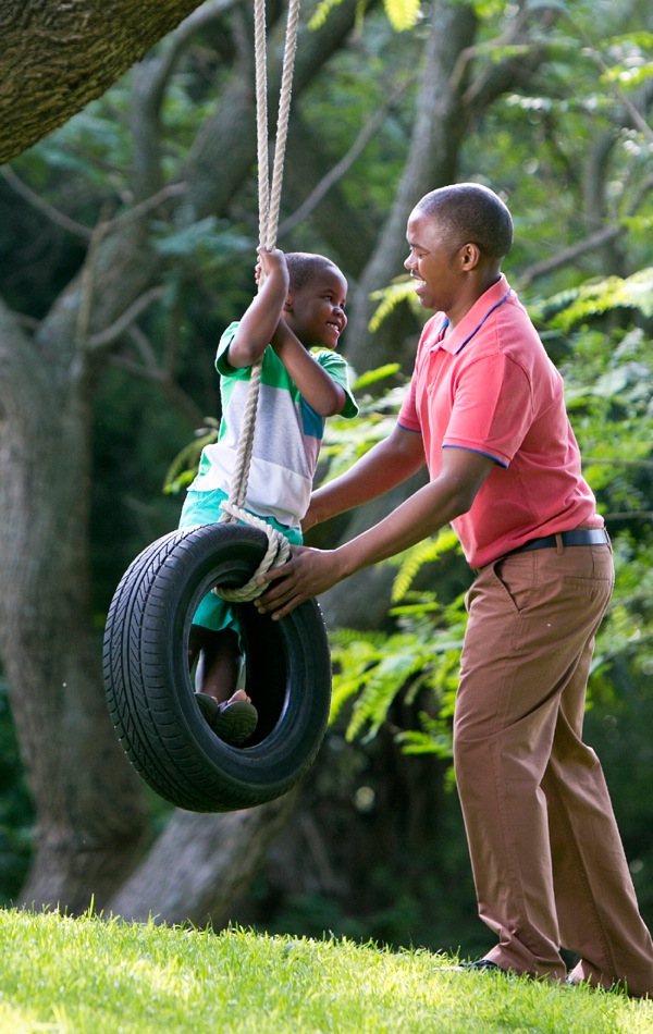 A father plays with his young son