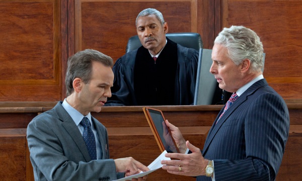 In modern times, a judge listens as two men debate