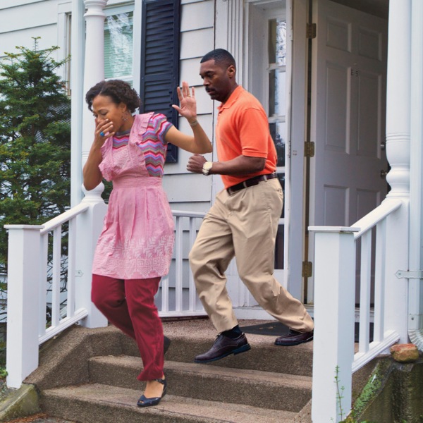 A husband and wife escaping from their contaminated home into the fresh air outside