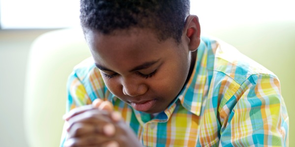A young boy praying