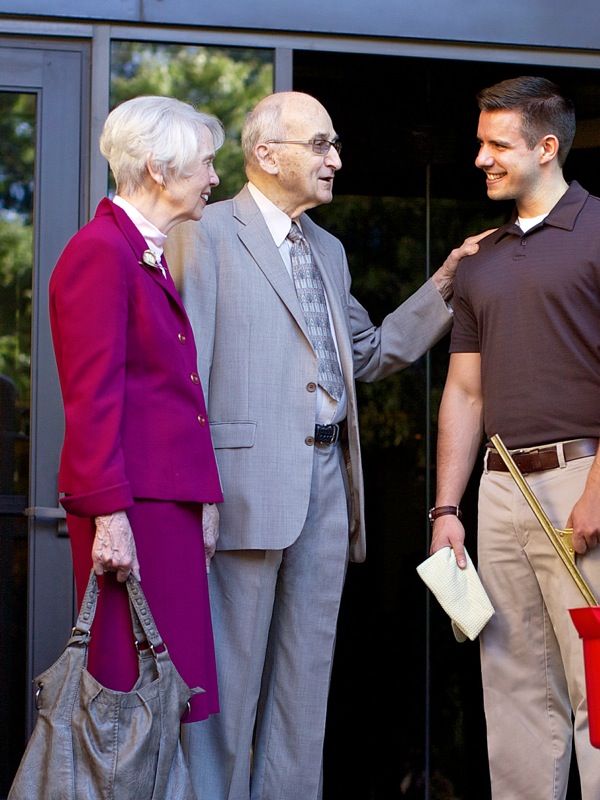 Robert and Lorraine Wallen talking to a young man serving at Bethel