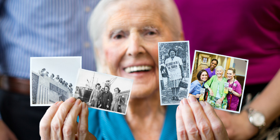 An older sister holds up photos of herself sharing in various features of the ministry