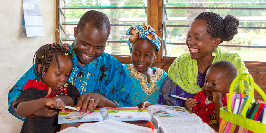 A couple who are Jehovah’s Witnesses study the Bible with their children