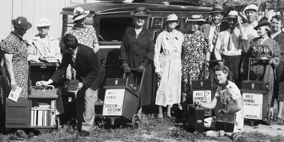 A group of Jehovah’s Witnesses prepare to go out in the ministry with portable phonographs