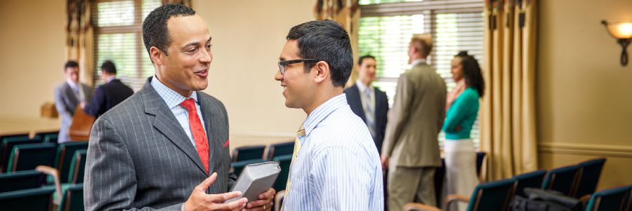 Two Christian brothers converse in a Kingdom Hall