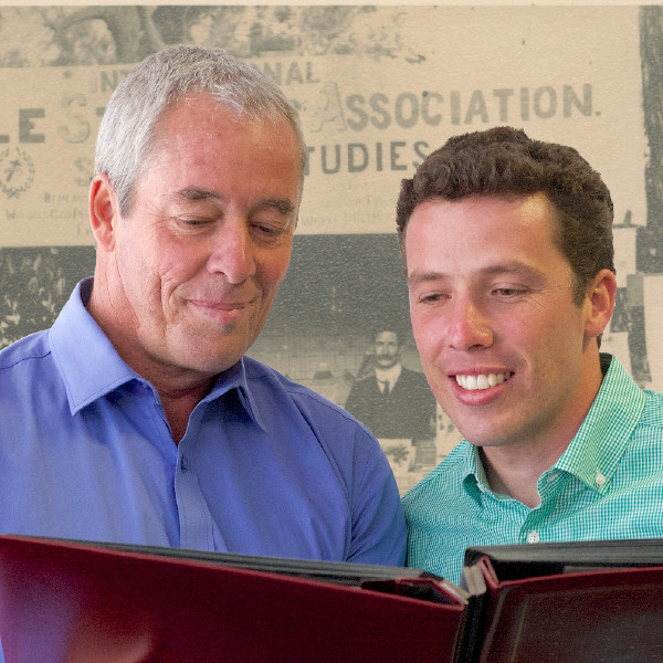 A father and son looking at old pictures of their family